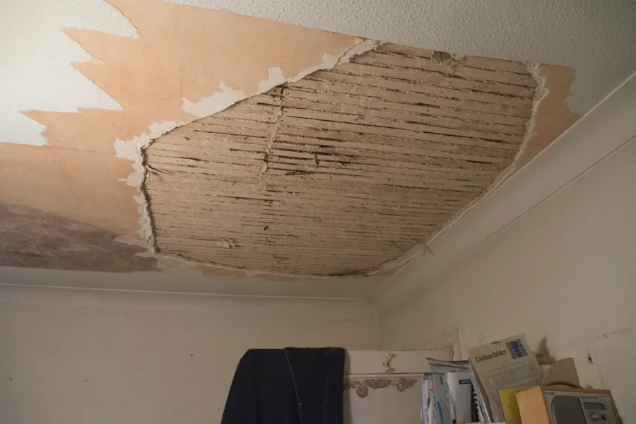 Plaster ceiling opened up by a long water leak